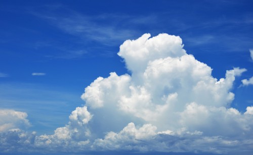 A fluffy cloud in a blue sky